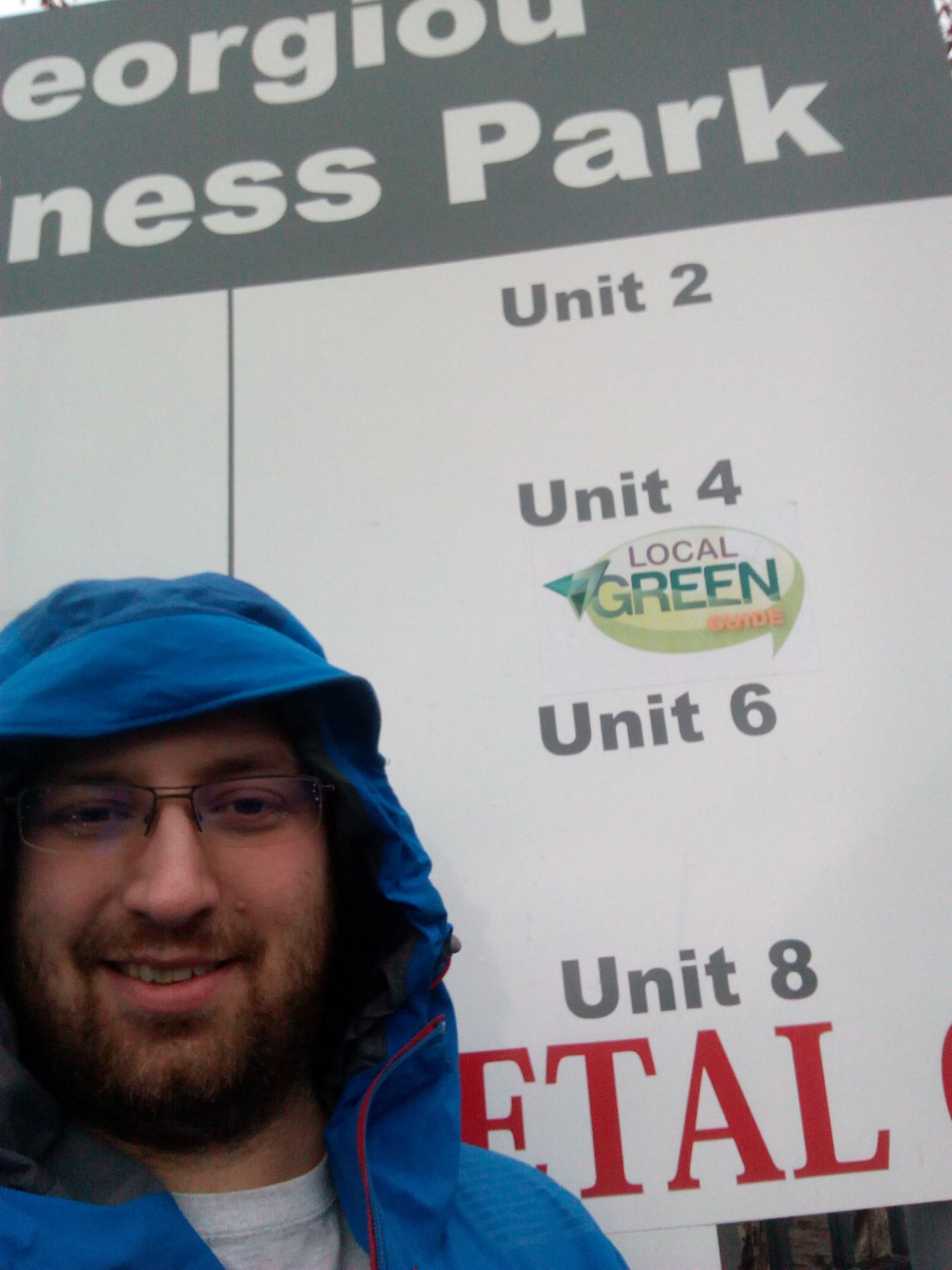 James Atherton standing beside Georgiou Business Park sign