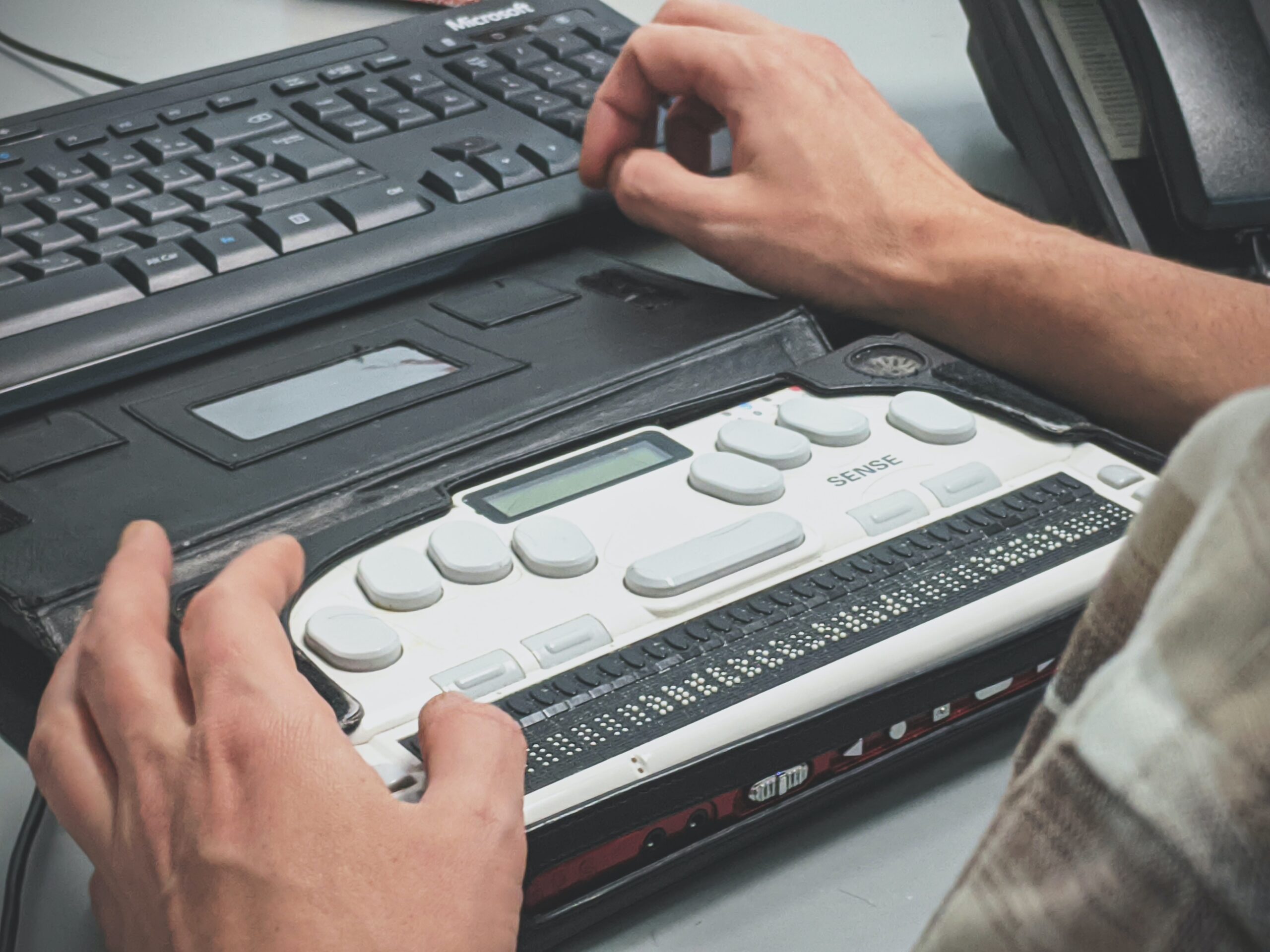 A person using a Braille writer